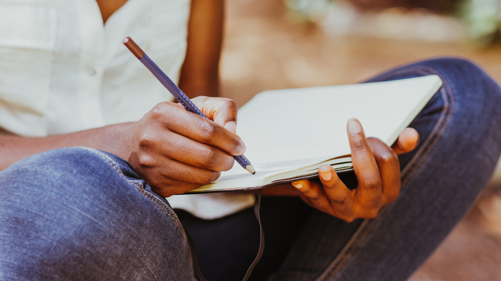 Journal woman sitting cross legged writing in a journal