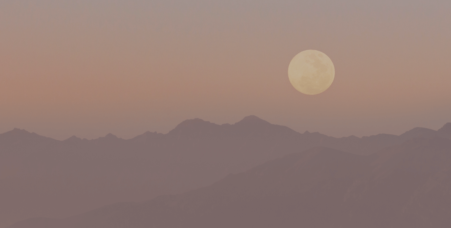 Journal a pink sunset over mountains with a full moon