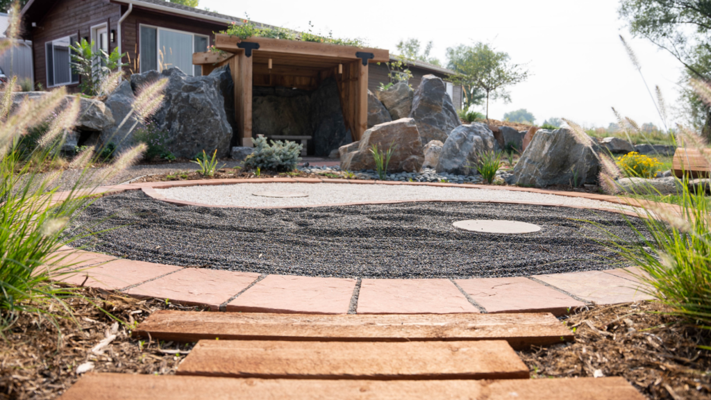 steps leading to a rock garden with black and white stones