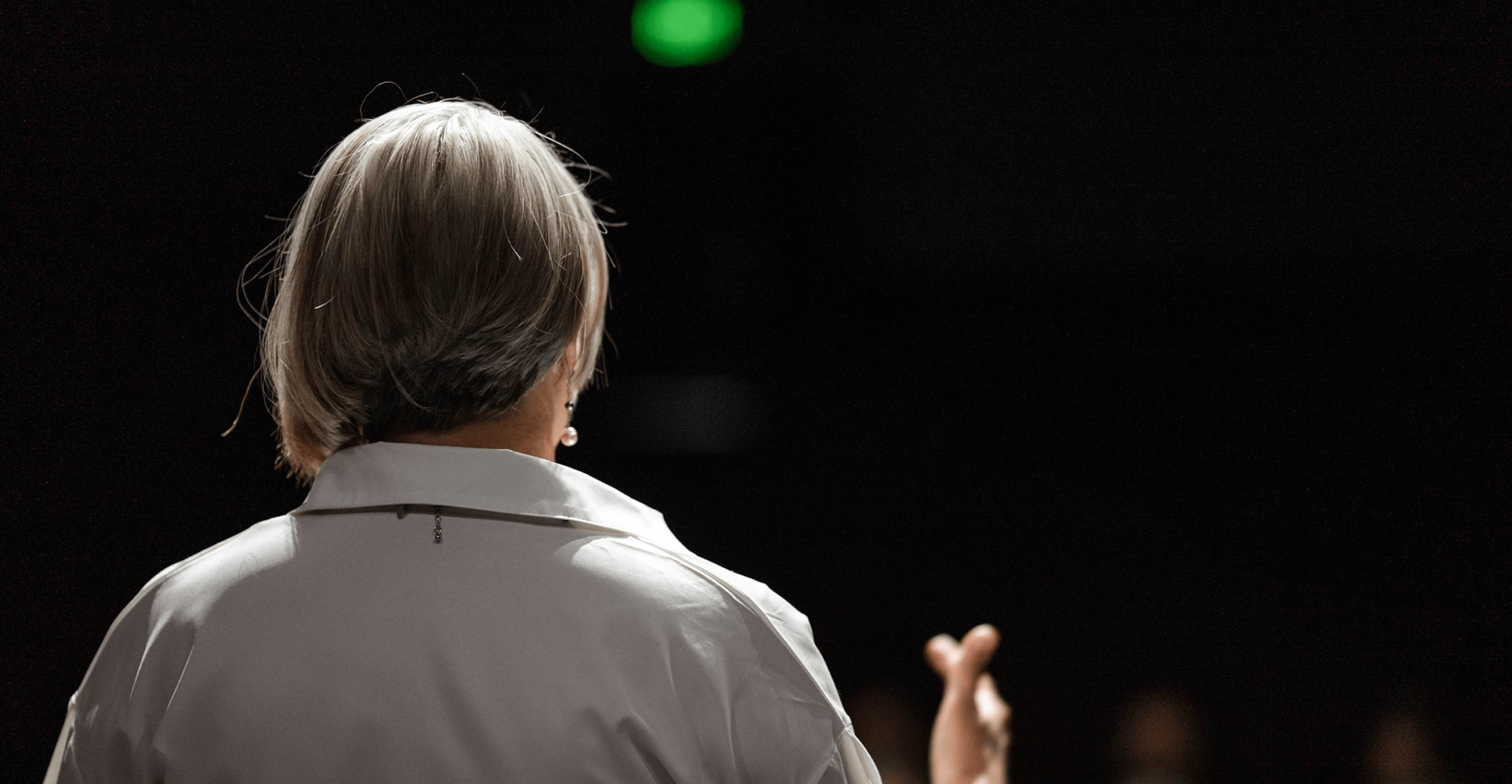 Speaking Close up of the back of Krystal Jakosky's head on stage