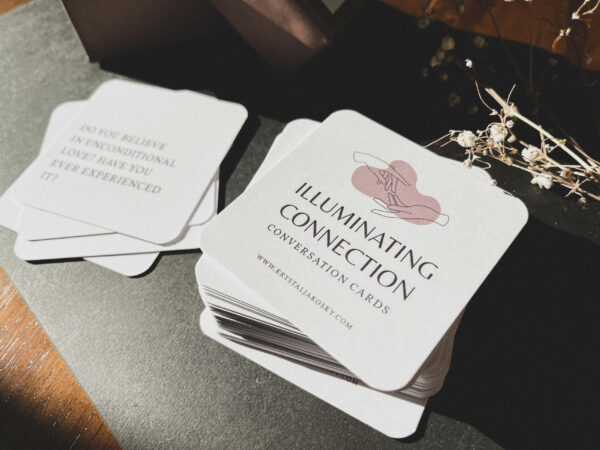 a deck of tan and purple cards on a black surface