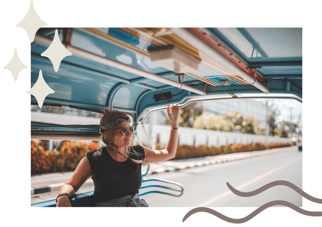 woman sitting in the back of a truck with her hand on the railing