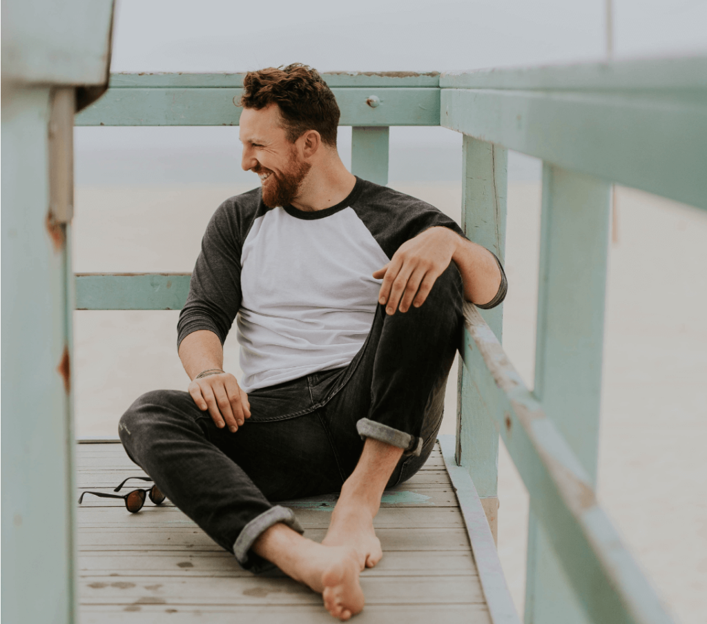 man sitting on a balcony smiling