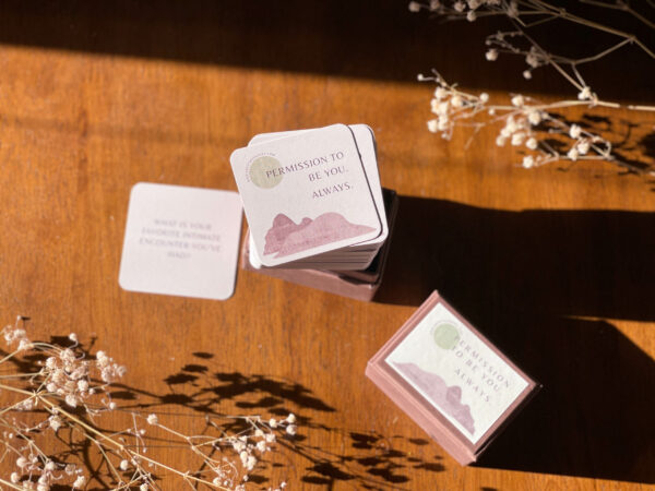 a deck of purple and tan cards on a wooden surface