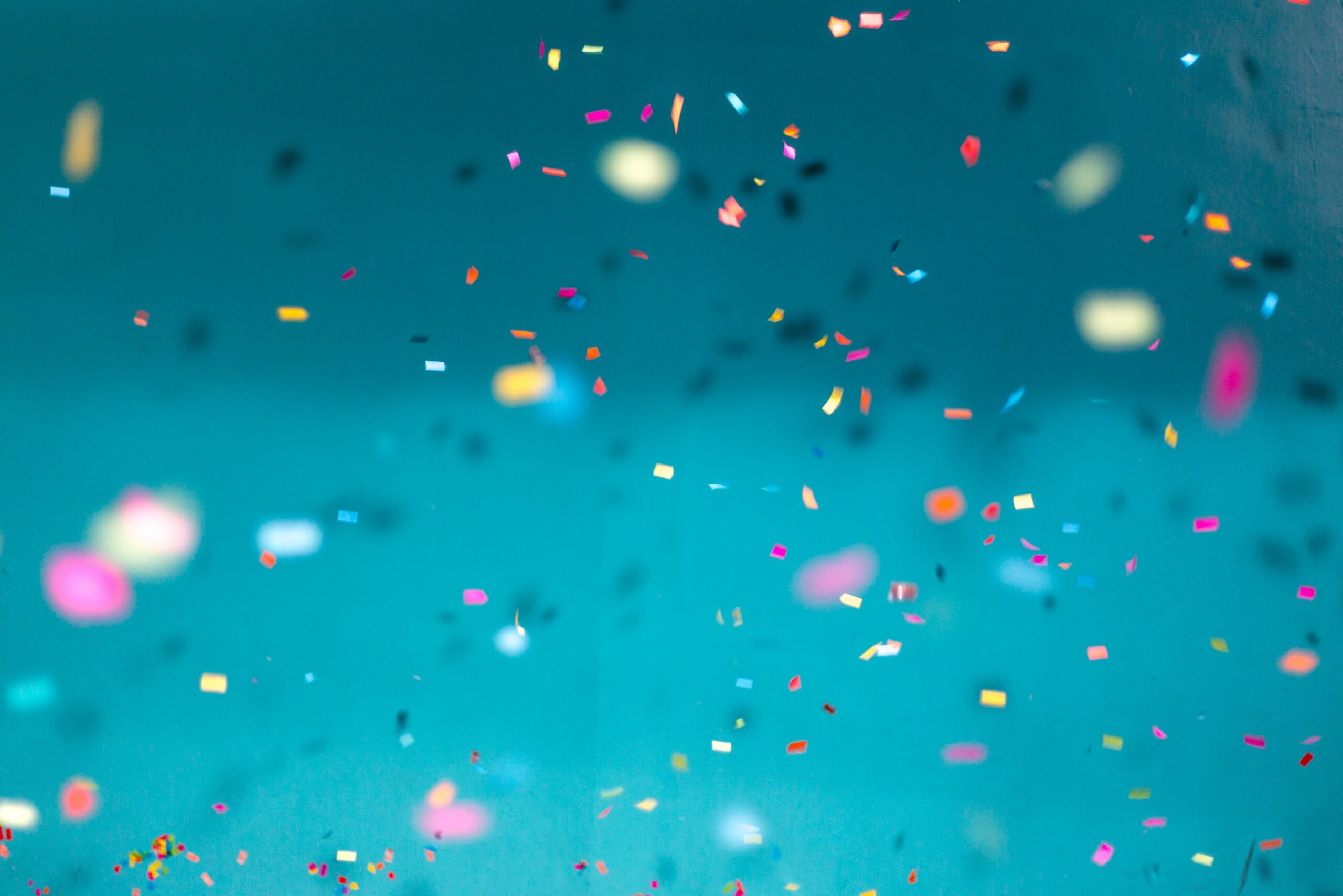 Podcast close up of blue background with rainbow confetti