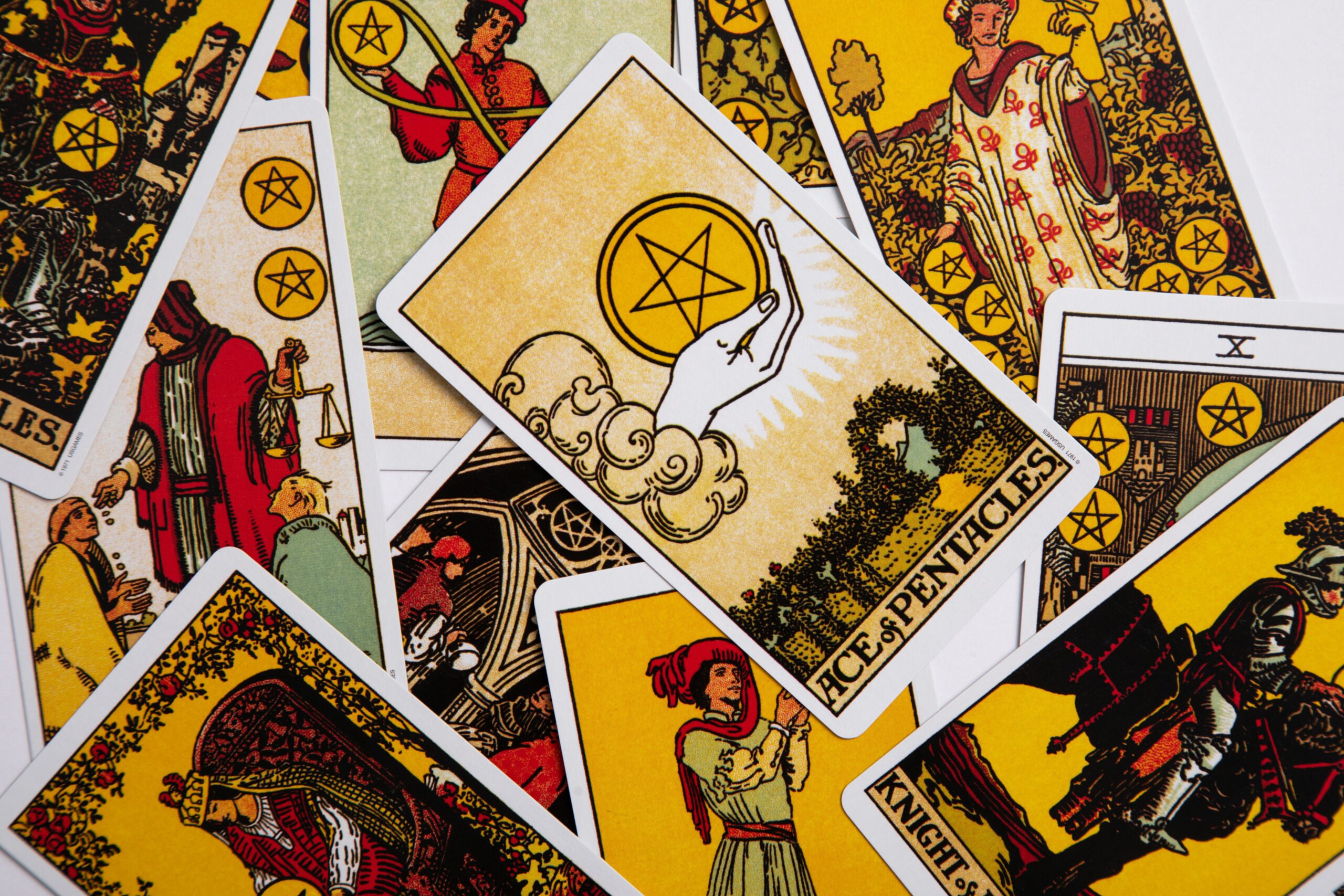 Podcast birds eye view of a collection of yellow and orange tarot cards