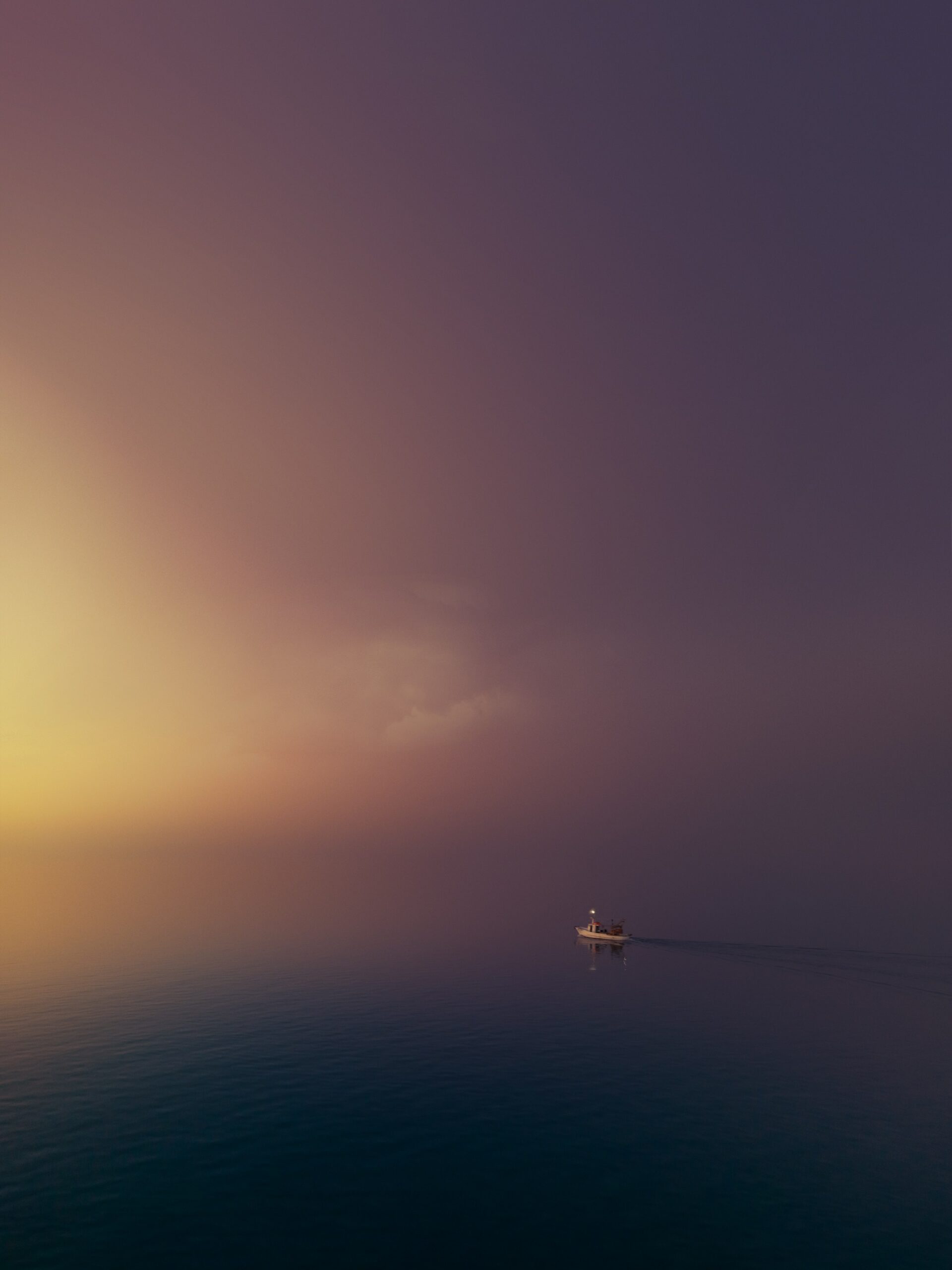 Journal a lone boat in the middle of a black sea with purple and yellow sky
