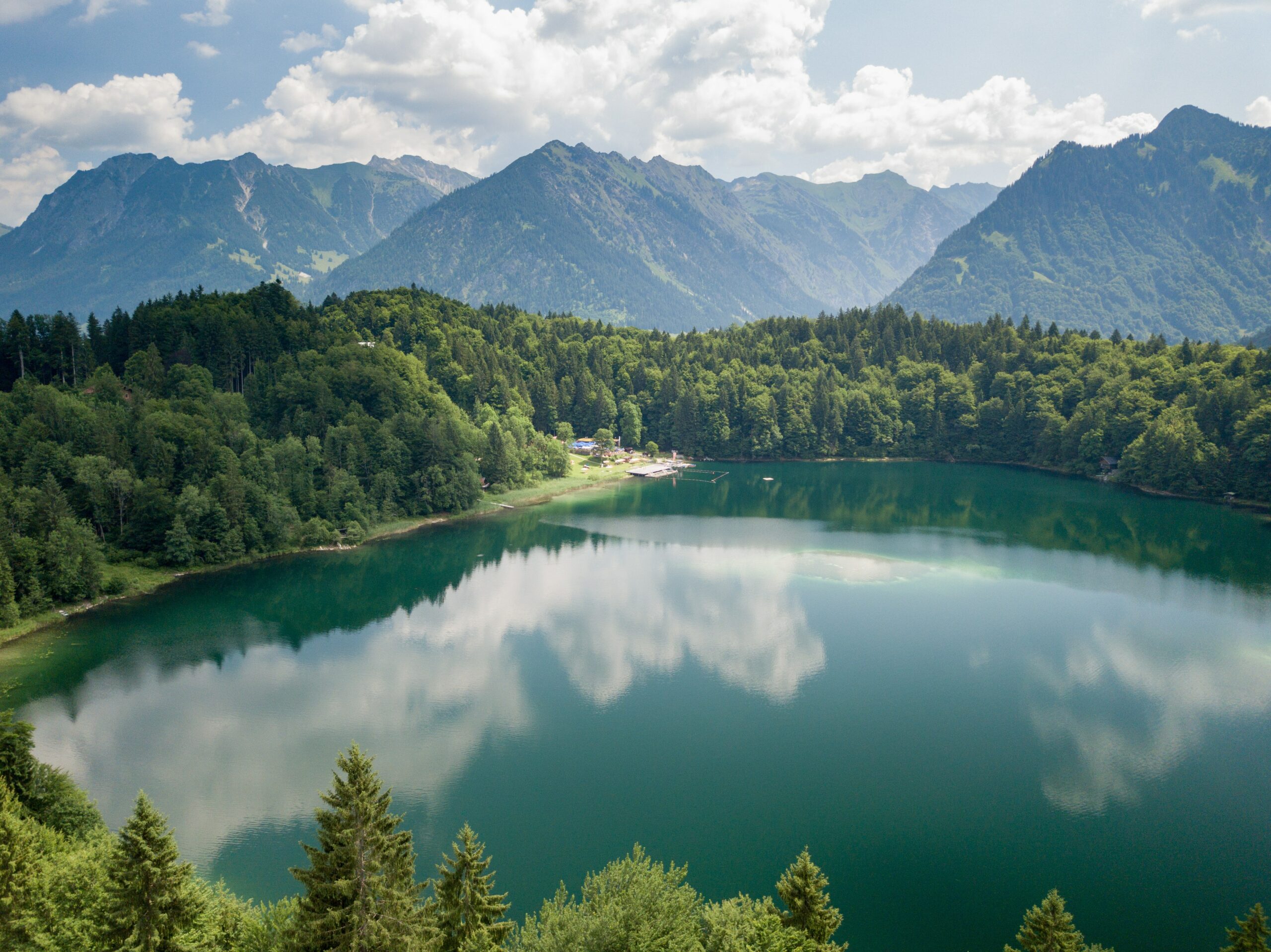 Journal a wide photo of a clear blue lake in the mountains